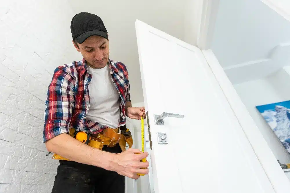Handwerker vermisst Türschloss mit Maßband für präzisen Einbau eines neuen Schlosses | Yapar's Schlüsseldienst